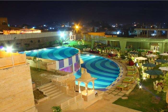 2-level swimming pool and the surrounding lawn at the Radisson Blu Resort