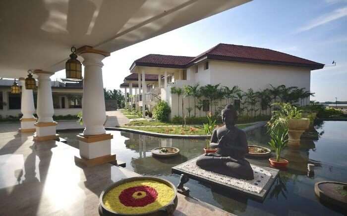 A Buddha statue in Windflower Resort and Spa Pondicherry on a bright day