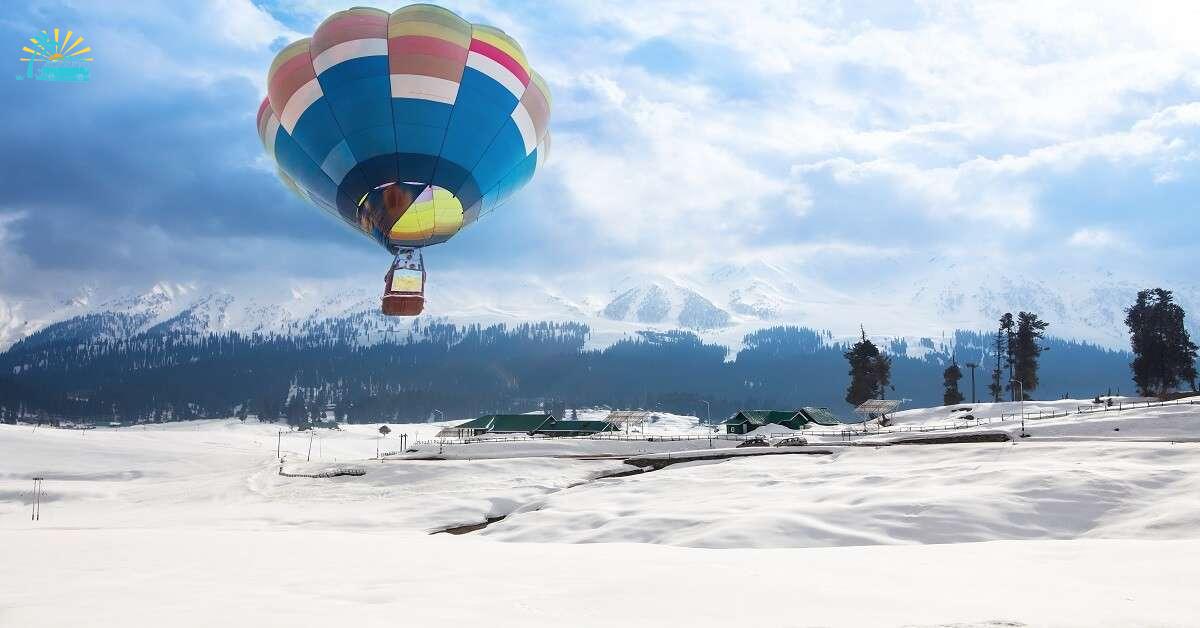 A hot air balloon flying over a village in Gulmarg in Kashmir