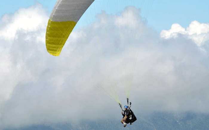 A person paragliding- which is one of the best things to do in Mukteshwar