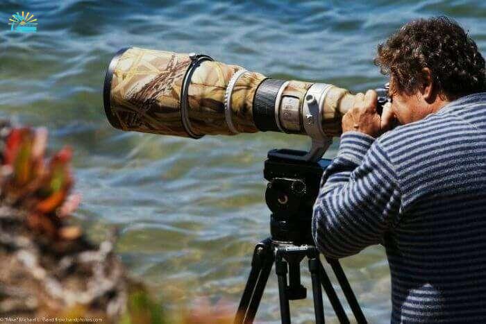 A professional photographer busy clicking pictures of nature as he travels