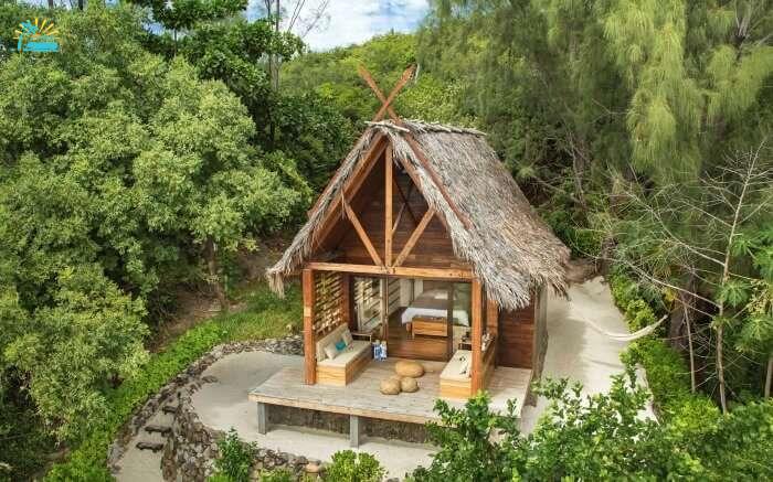 A thatched bungalow surrounded by lush greenery in Tsarabanjina in Madagascar