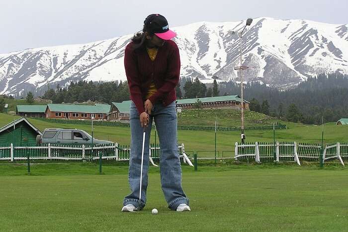 A tourist ready to tee off at the Gulmarg golf course