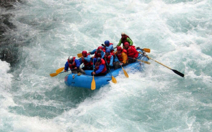 Adventurers taking up river rafting while on their camping trip in Rishikesh