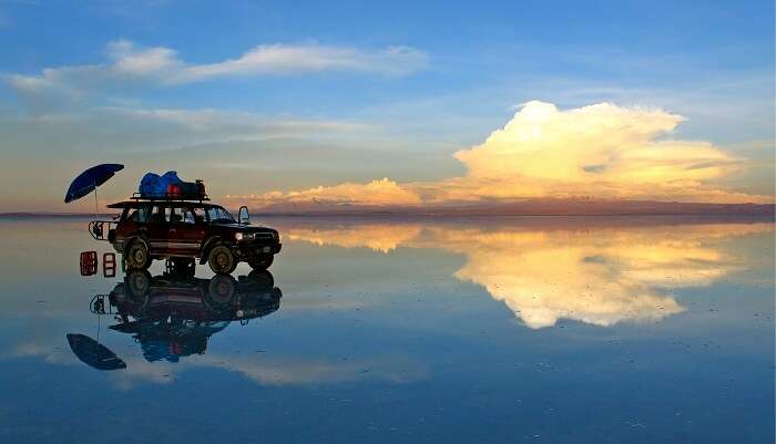 An SUV and its reflection at the Salar De Uyuni nature fields