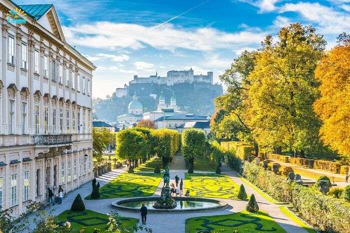 Beautiful view of famous Mirabell Gardens with the old historic Fortress Hohensalzburg in the background in Salzburg