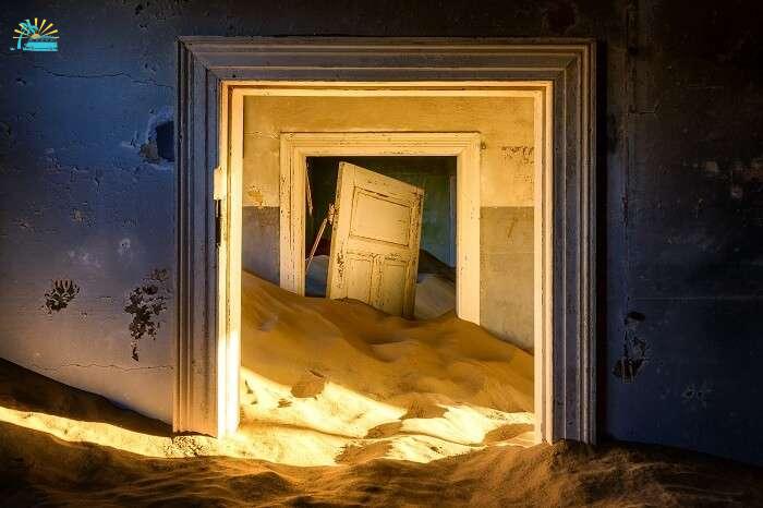 Building taken over by sand at the former diamond mining town of Kolmanskop in Namibia