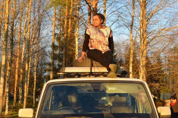 Nidhi relaxing on top of the car like a boss