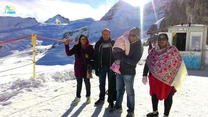 Enjoying a special family moment on top of the snow covered Alps