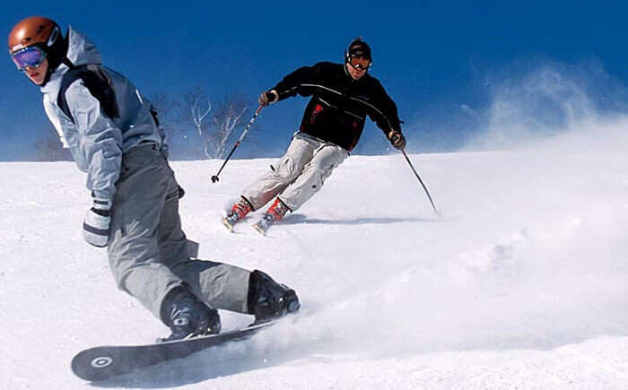 People try skiing and snowboarding at Pahalgam