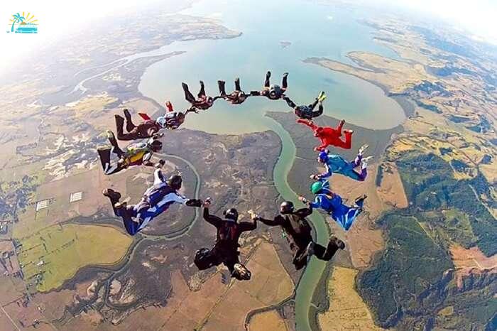 Professional skydivers performing aerobatics in Auckland