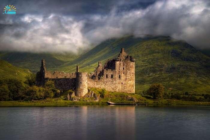 Reflections of the Kilchurn Castle in morning light in Scotland