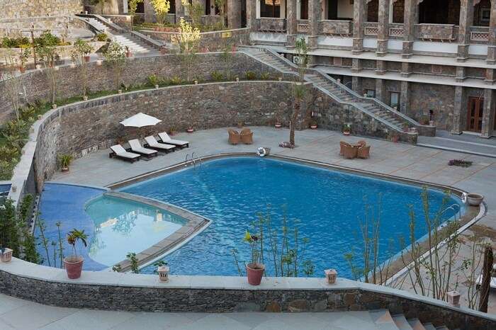 Swimming pool and stone stairways leading to the pool at Ramada Resort near Udaipur