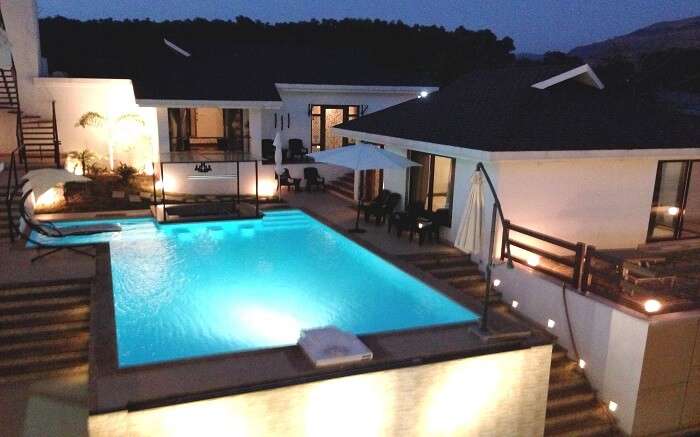 The well lit pool of Casa Dios Luxury Villas in Lonavala