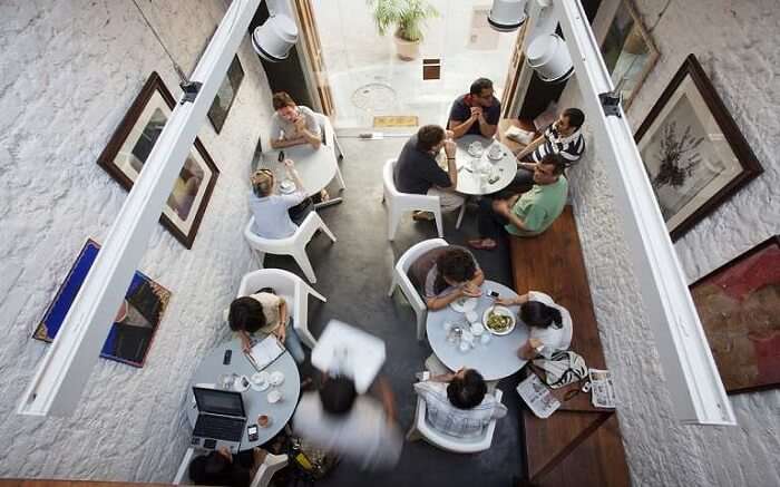 Top view of people sitting together having food at Kala Ghoda Cafe in Mumbai