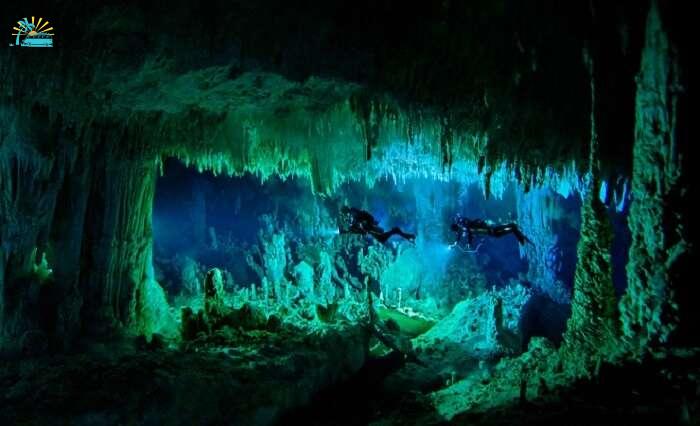 Two persons engaging in cave diving