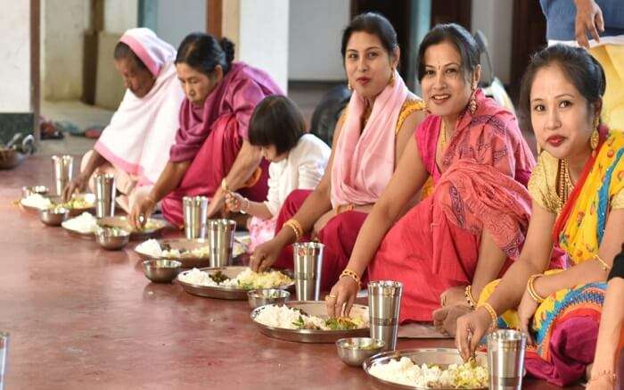 Women of Manipur enjoying a traditional meal during a festival