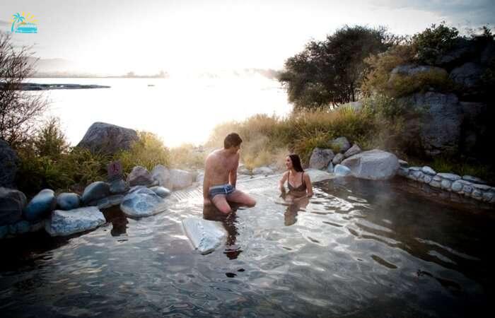 Couple taking a shower in a pool in Tarawera in Rotorua