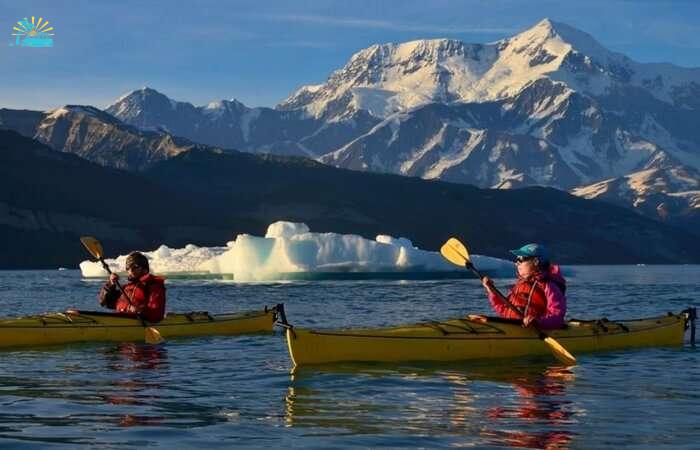 Couple canoeing in a lake in St. Elias National Park and Preserve in Alaska