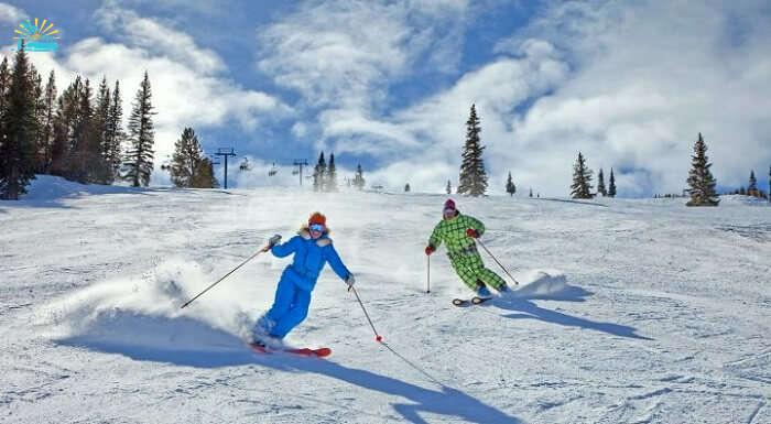 couple skiing in aspen