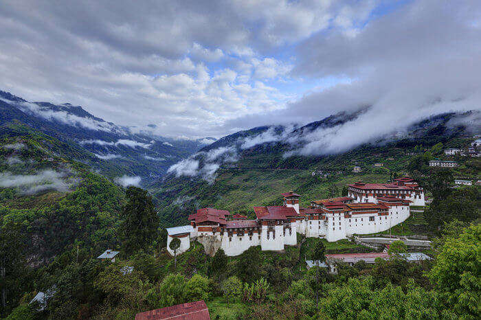 Bumthang monastery and mountains surrounded by clouds